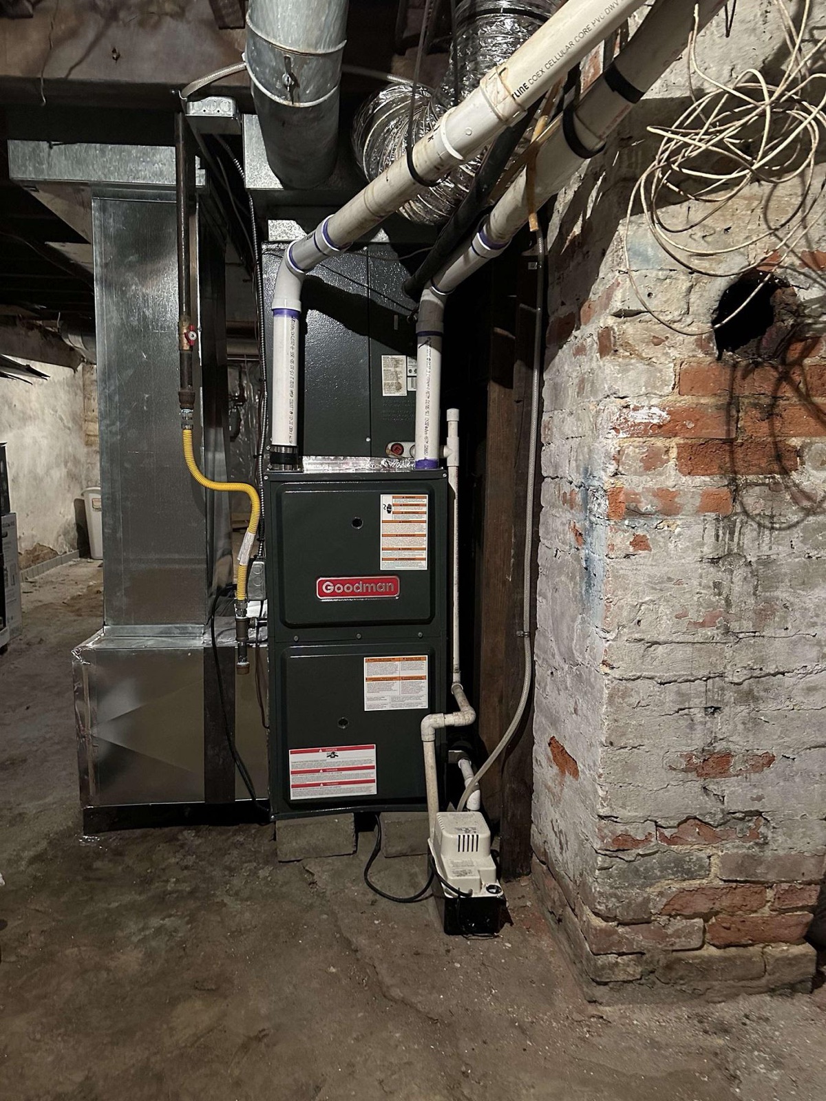 New Goodman high-efficiency gas furnace and coil installed in a basement